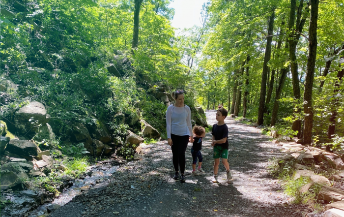 Jenn Hoos Rothberg walking with her children in a park.