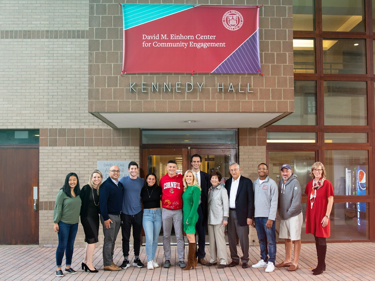 Group photo of Itai Dinour, the Einhorn family, the Einhorn Collaborative team, and Cornell staff and students in front of the Einhorn Center.